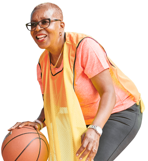 woman smiling and dribbling basketball
