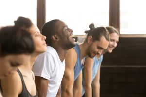 A group of people taking an exercise class for employee mental health.