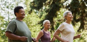 A group of women jogging in a park.