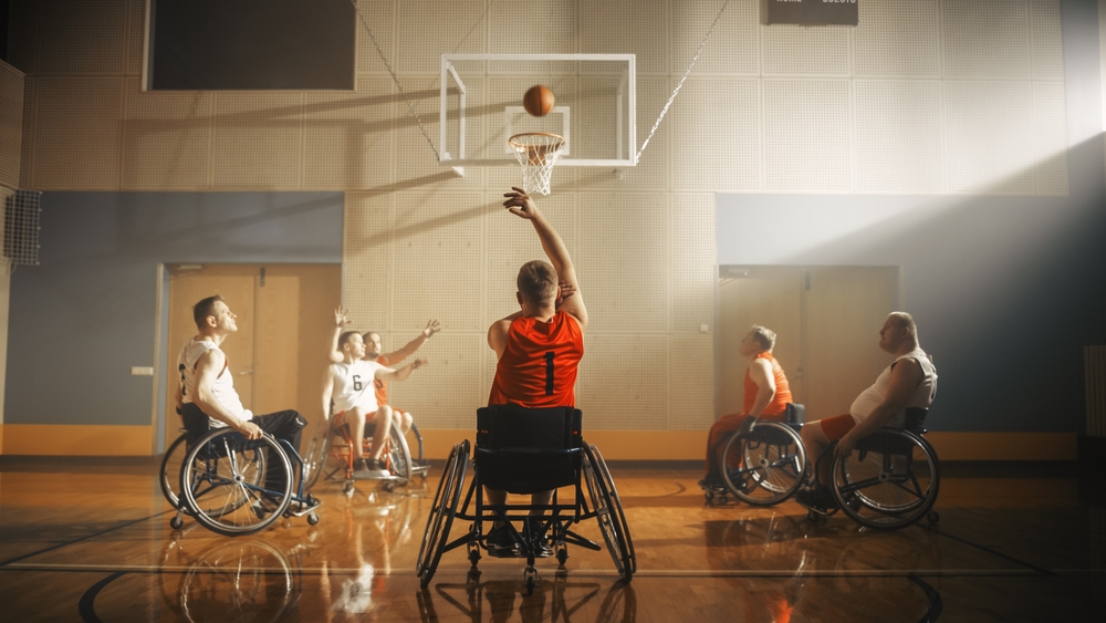  A group of people playing wheelchair basketball. 