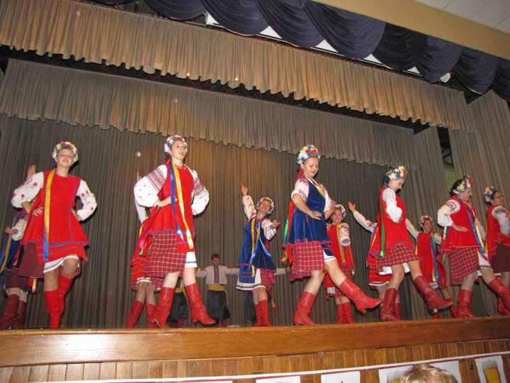 A group of Ukrainian dancers performing on a stage. 