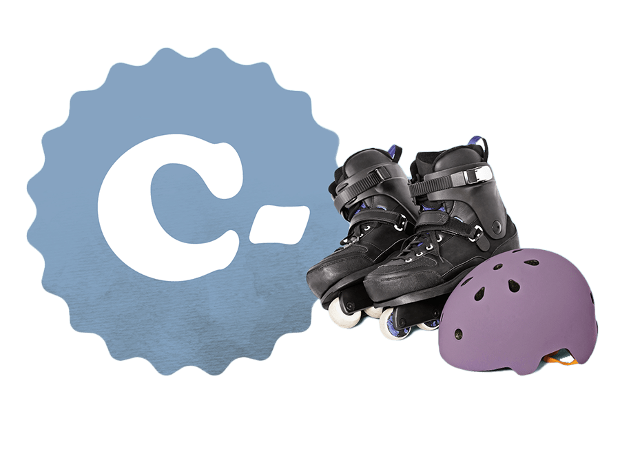 A C- grade beside a pair of rollerblades and a helmet.