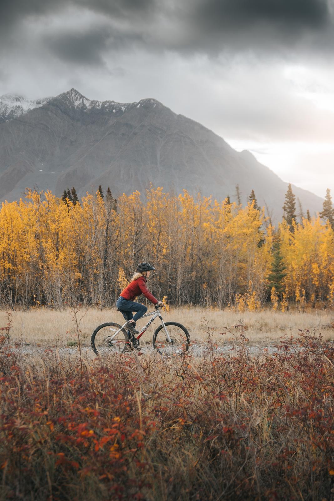 A person biking beside a mountain. A person biking beside a mountain.