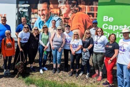 Residents of Red Deer, Alberta standing on a field in front of a billboard. Residents of Red Deer, Alberta standing on a field in front of a billboard.
