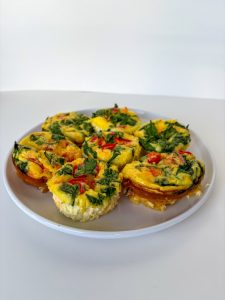 Veggie and cheese egg bites on a plate.