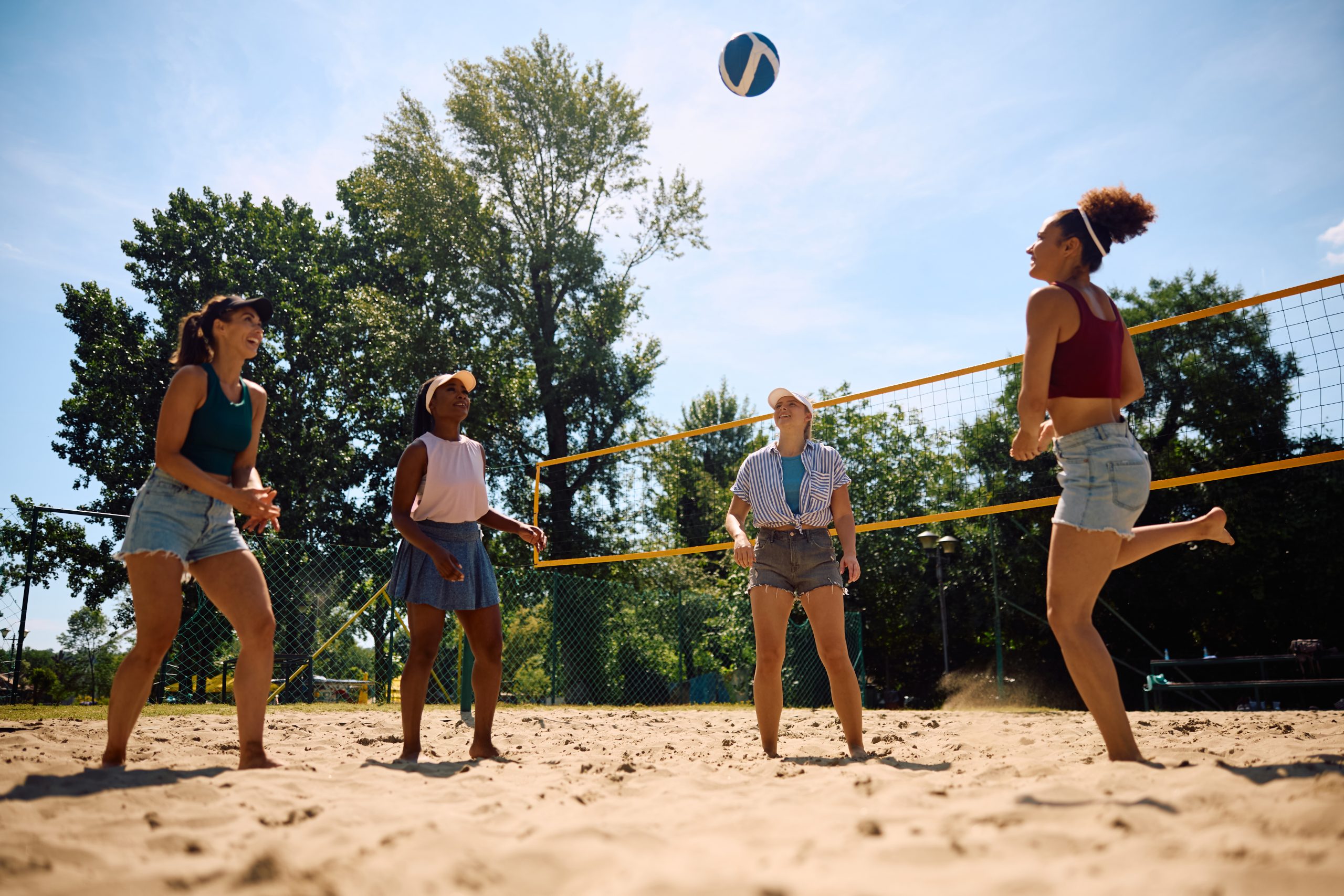 A group of women playing outdoor beach volleyball. A group of women playing outdoor beach volleyball.