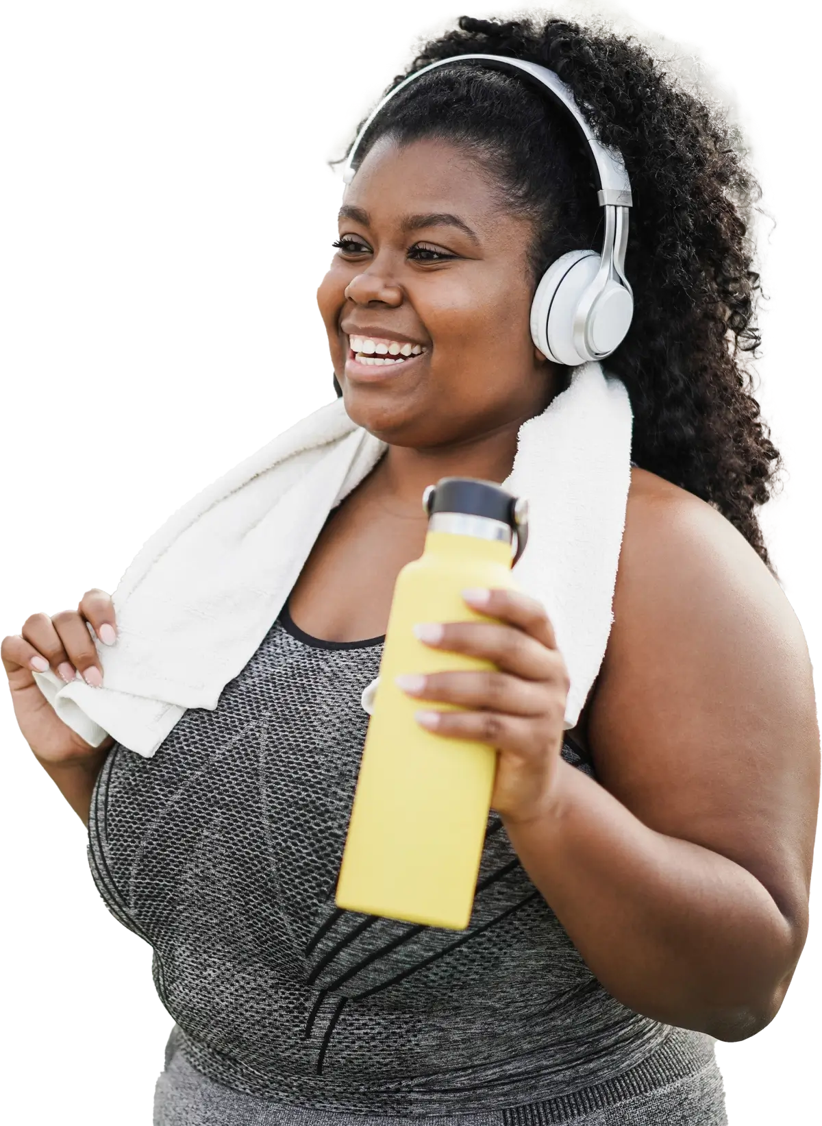 curvy-woman-doing-workout-morning-routine-outdoor-final-image A smiling woman wearing headphones and workout clothes while holding a water bottle.