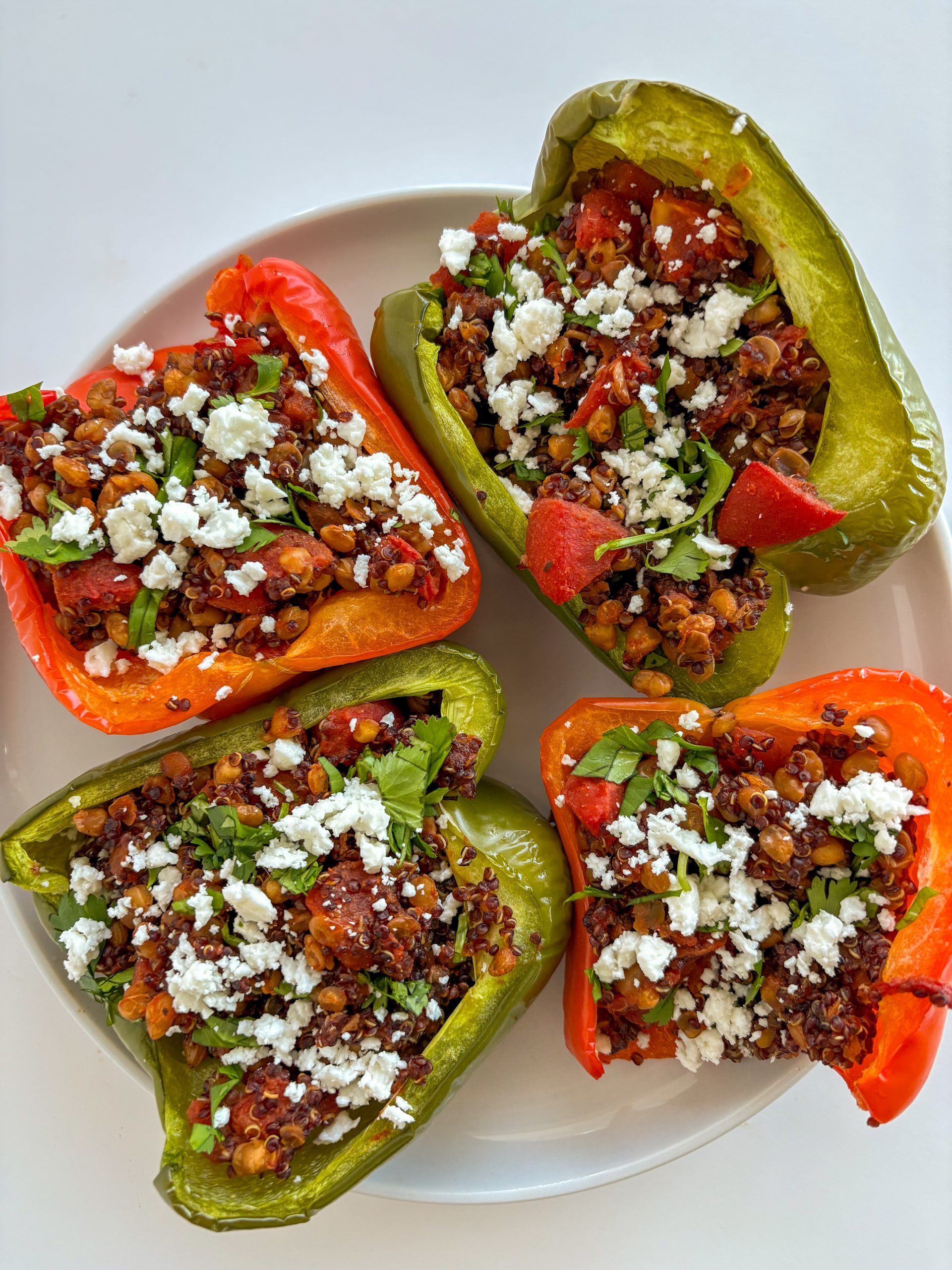 Lentil- and quinoa-stuffed peppers on a plate. Fuel your movement recipe of the month: Lentil- and quinoa-stuffed peppers